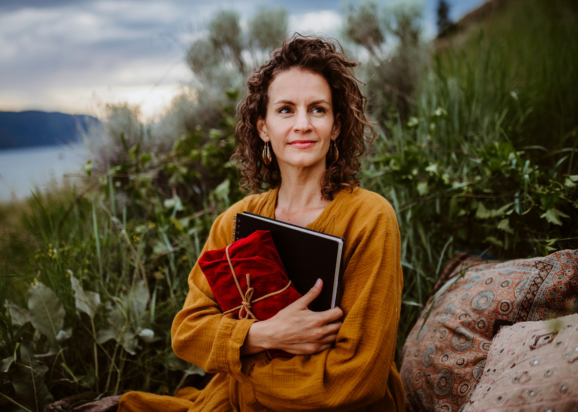 A woman hold a journal outdoor