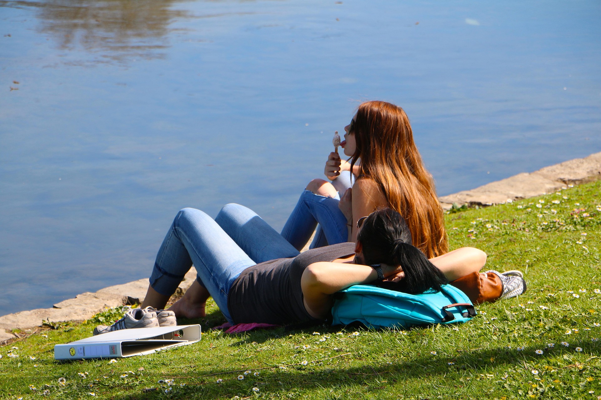Women by the lake on a sunny day enjoying ice-cream