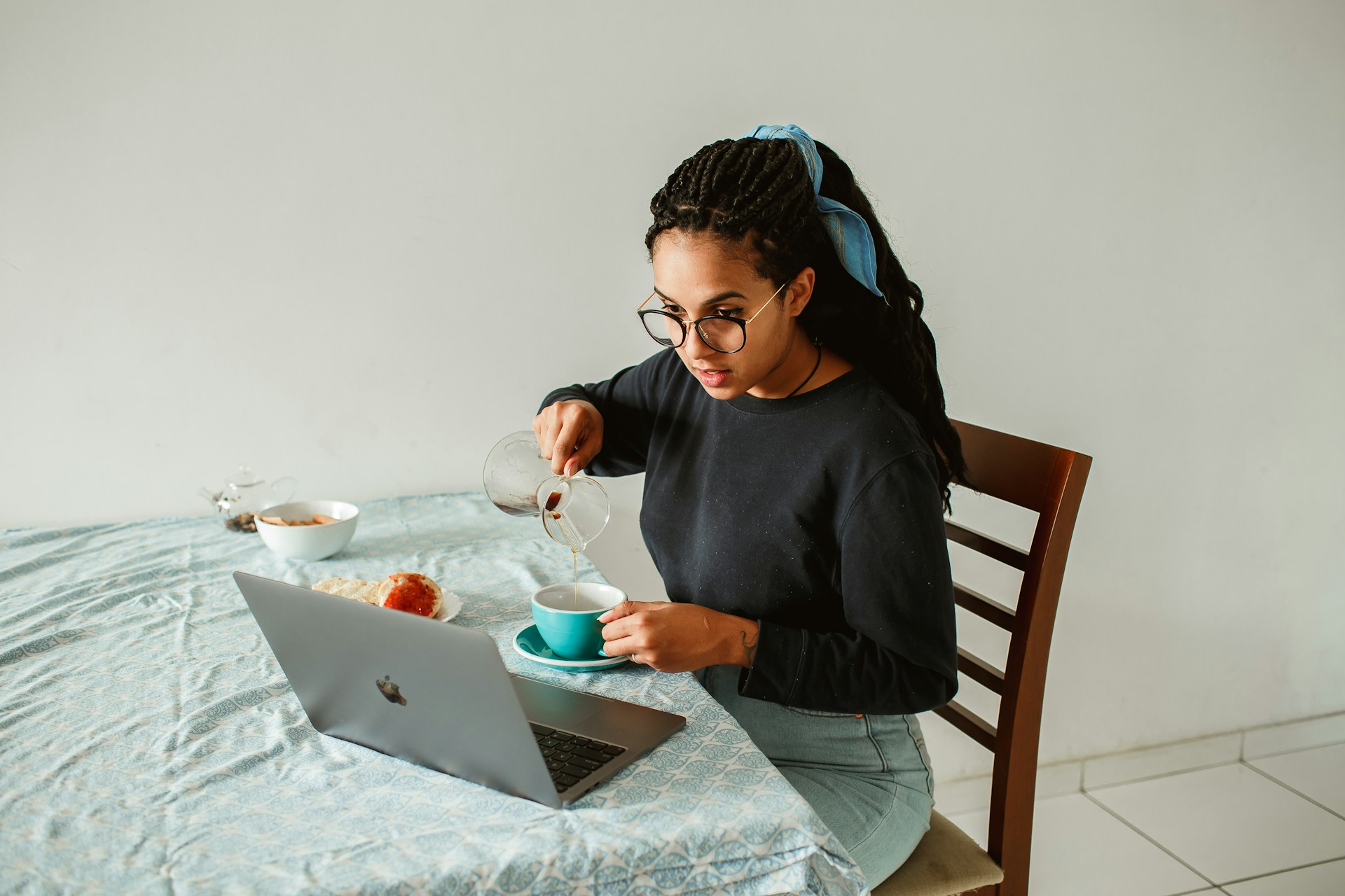 A Woman working and eating breakfast