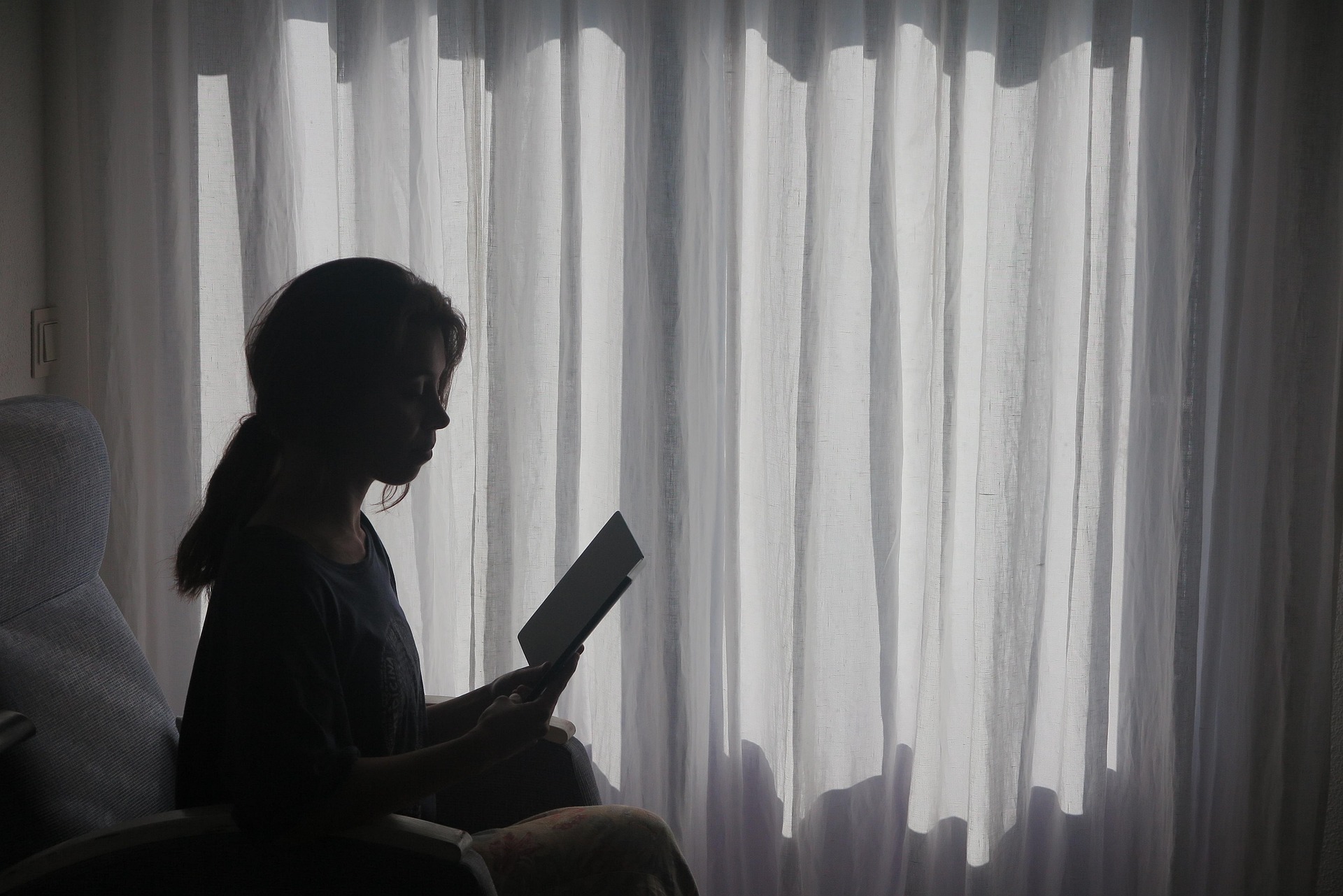 A woman reading in her cozy reading nook